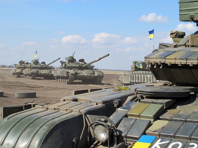 Ukrainian tanks drive through barren field