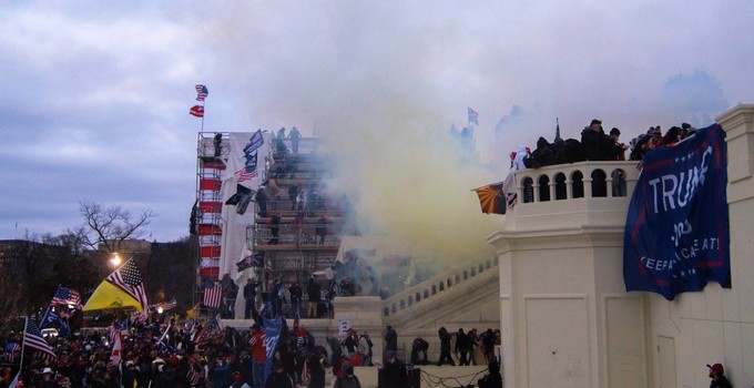 Clouds of tear gas over crowds breaching the US Capitol on January 6, 2021